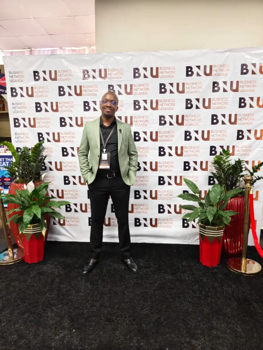 An attendee posing in front of the branded photo wall at the BNU Launch.